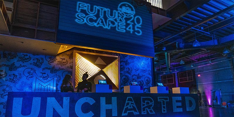 Room with black light with signage of "FuturScope2045" and "Uncharted" featured.