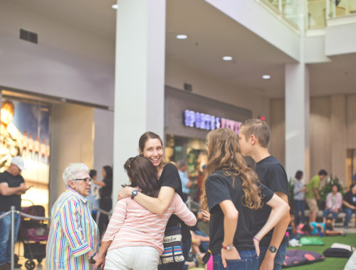 Smiling woman hugs a girl