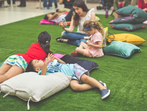 Kids lying on the pillows looking up the LED Constellation