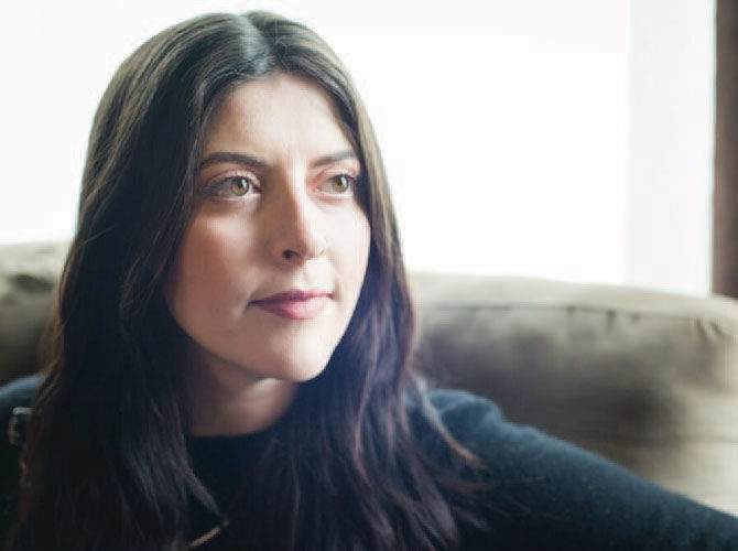 Close up photo of female with long dark hair.